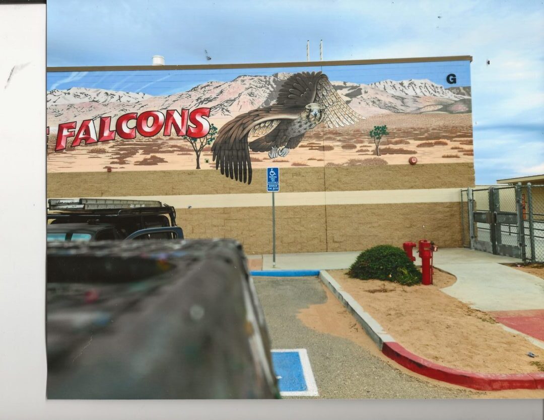 A picture of the outside of a building with a falcon on it.