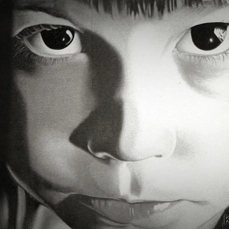 A black and white photo of a child 's face.